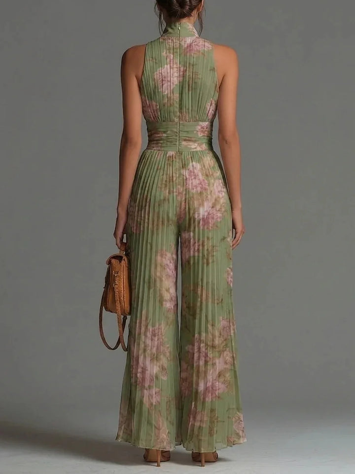 Front view of pleated wide leg jumpsuit showing deep V neckline and cinched waist detail with romantic floral pattern