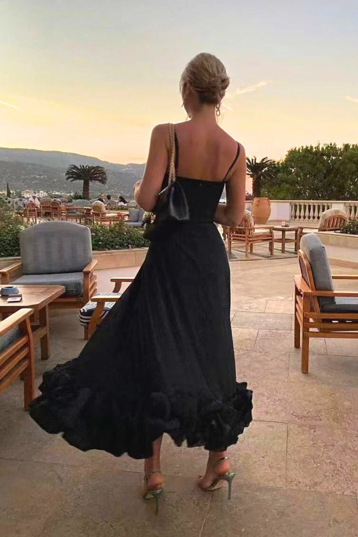 Full-length view of fitted bodice maxi dress with thin adjustable straps and flared skirt silhouette