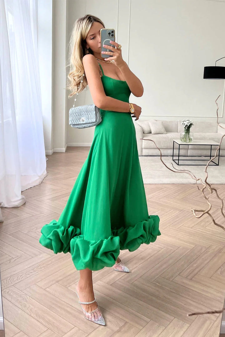 Back view of spaghetti strap maxi dress showing straight neckline and flared skirt with ruffle hem