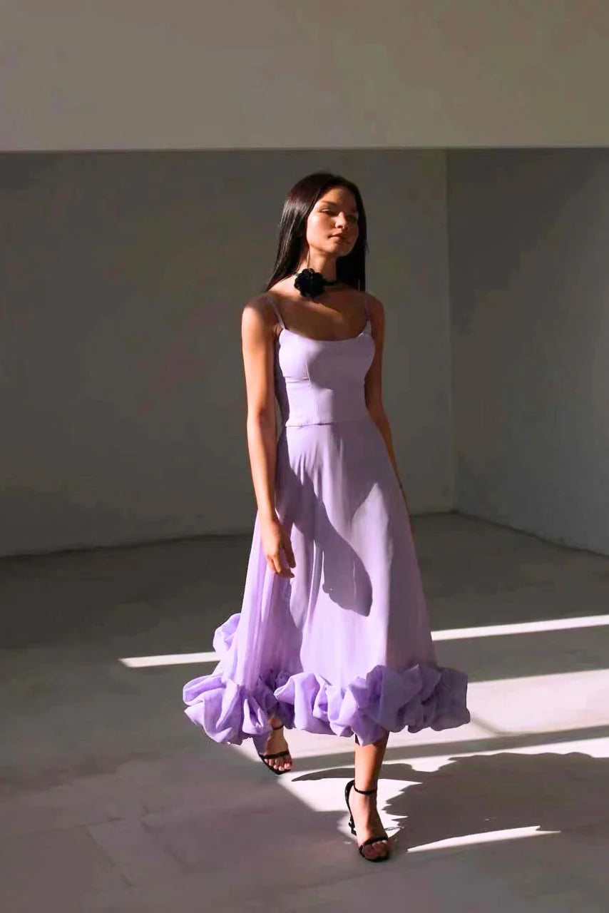 Spaghetti strap maxi dress in motion showing flared skirt movement and ruffle hem volume