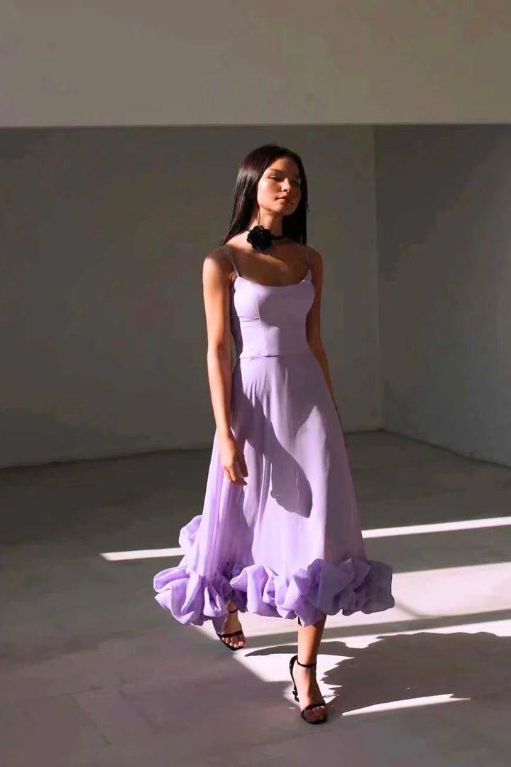 Spaghetti strap maxi dress in motion showing flared skirt movement and ruffle hem volume