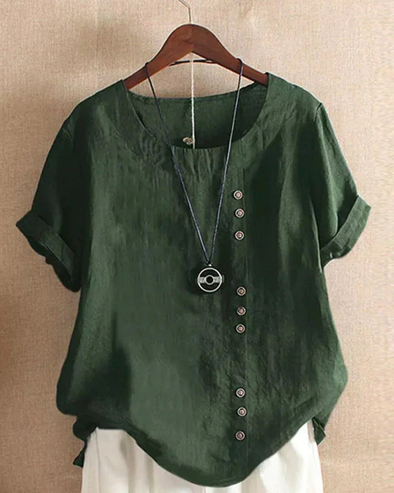 Close-up view of linen summer blouse showing soft woven fabric texture and round neckline construction