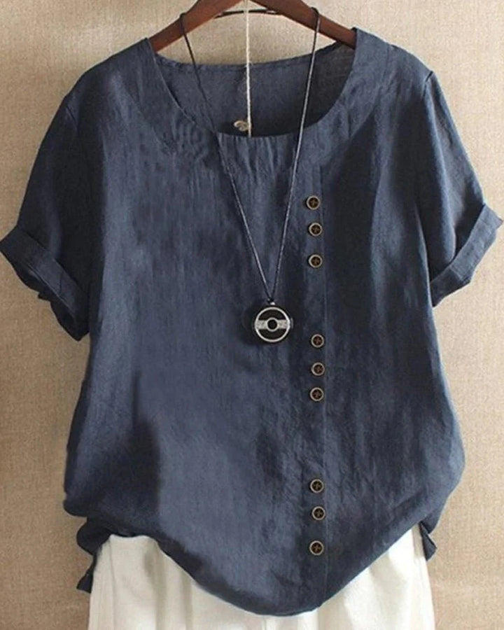 Side angle of short sleeve summer blouse displaying curved hemline and relaxed silhouette