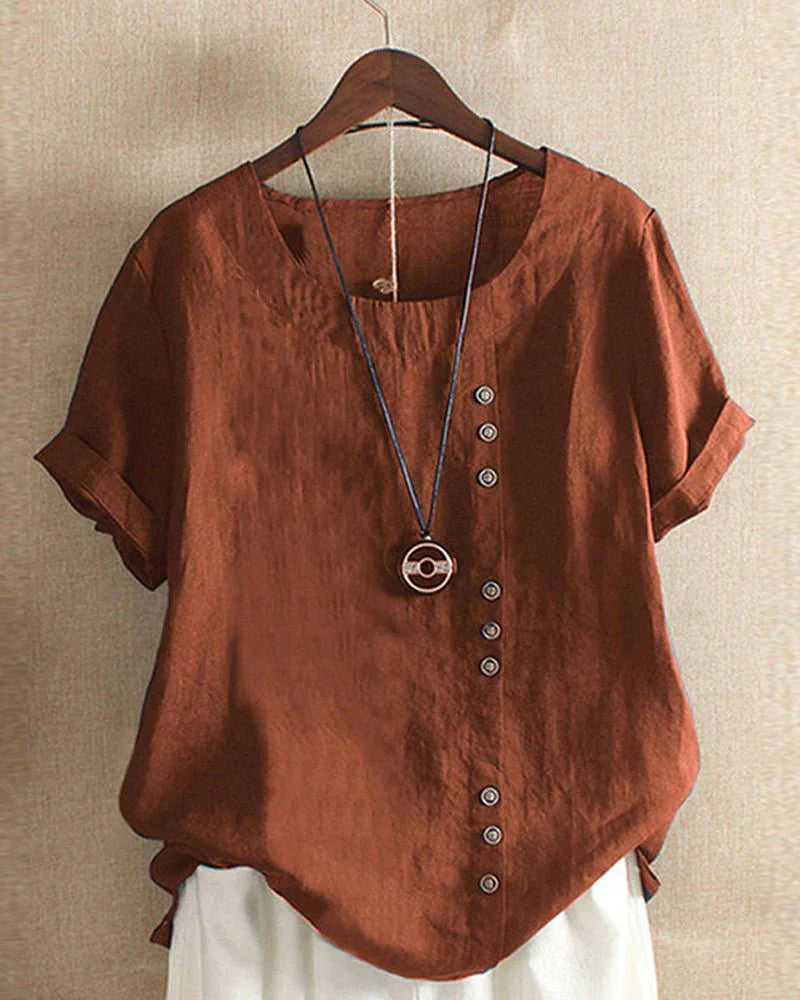 Detail shot of decorative button placket running along front of linen blouse