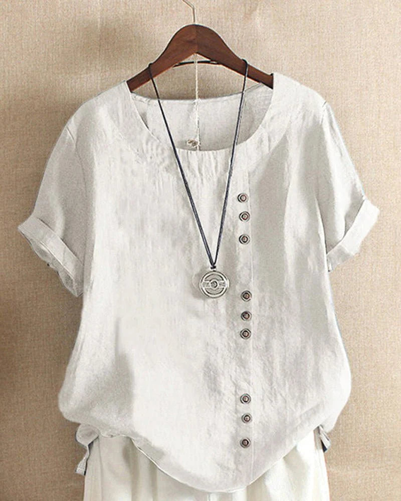 Linen summer blouse styled with white pants demonstrating versatile casual wear options