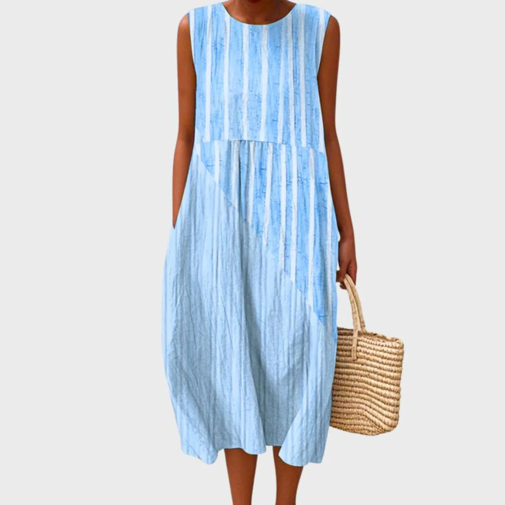 Close-up view of the tiered construction and plaid pattern on this sleeveless midi dress
