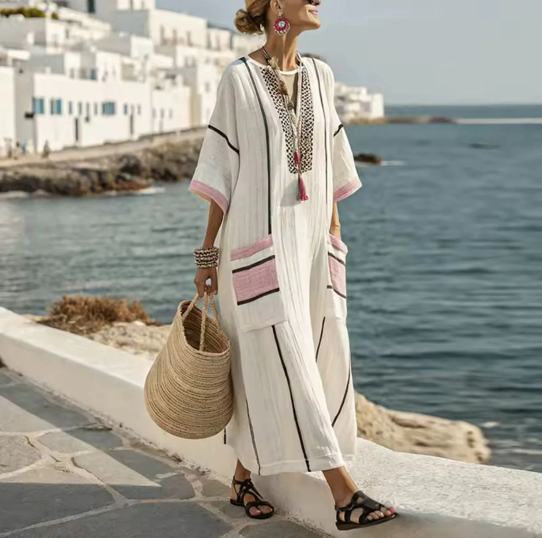 Side view of striped maxi dress showing relaxed silhouette and contrast trim detail on sleeves
