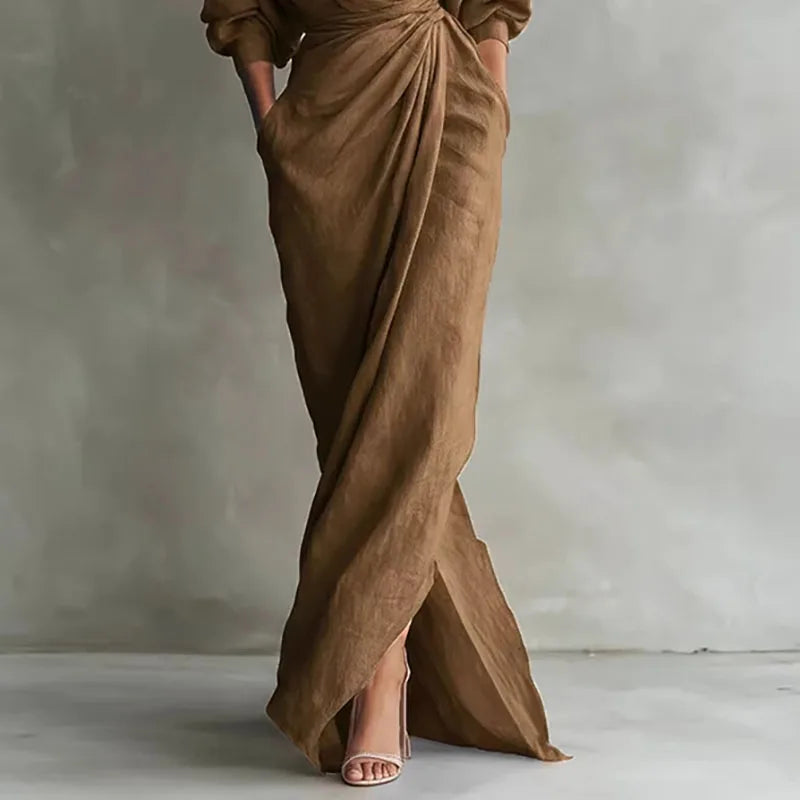 Close-up of wrap waist detail on long sleeve maxi dress in soft draped fabric