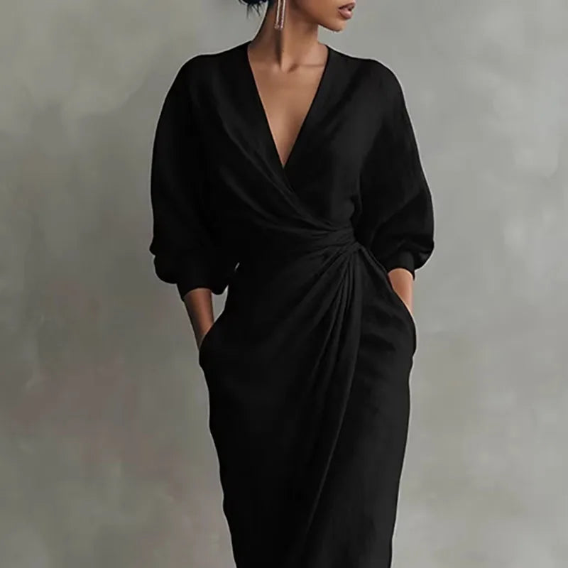 Model in V neck wrap waist long dress paired with strappy heels for evening wear