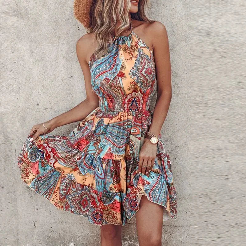 Detail of smocked waist panel and tiered skirt construction on backless printed summer mini dress
