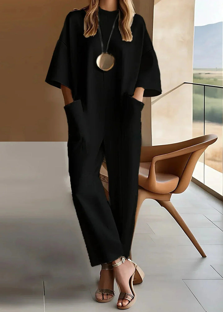 Close-up view of Elegant Short-Sleeve Jumpsuit showing clean crew neckline, structured fabric, and minimalist silhouette with straight-leg cut