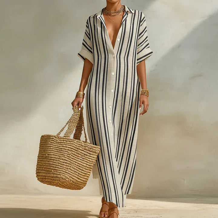Woman wearing striped Linen Long Shirt Dress with V-neckline and ankle length, holding woven tote bag in natural sunlight