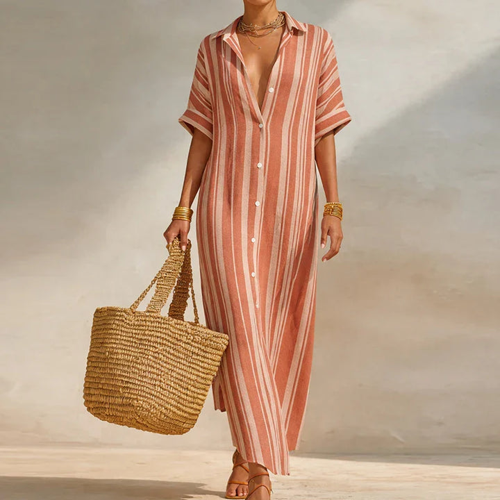 Side angle showing loose silhouette and straight hem of ankle-length striped dress with V-neck