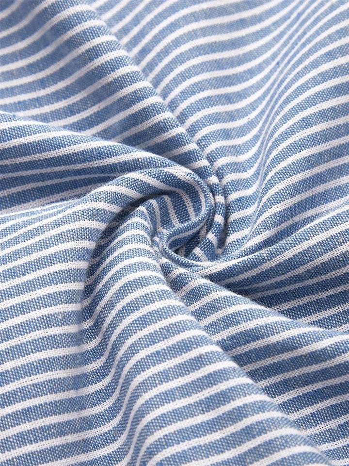 Side view of midi-length striped dress featuring functional pockets and relaxed A-line silhouette