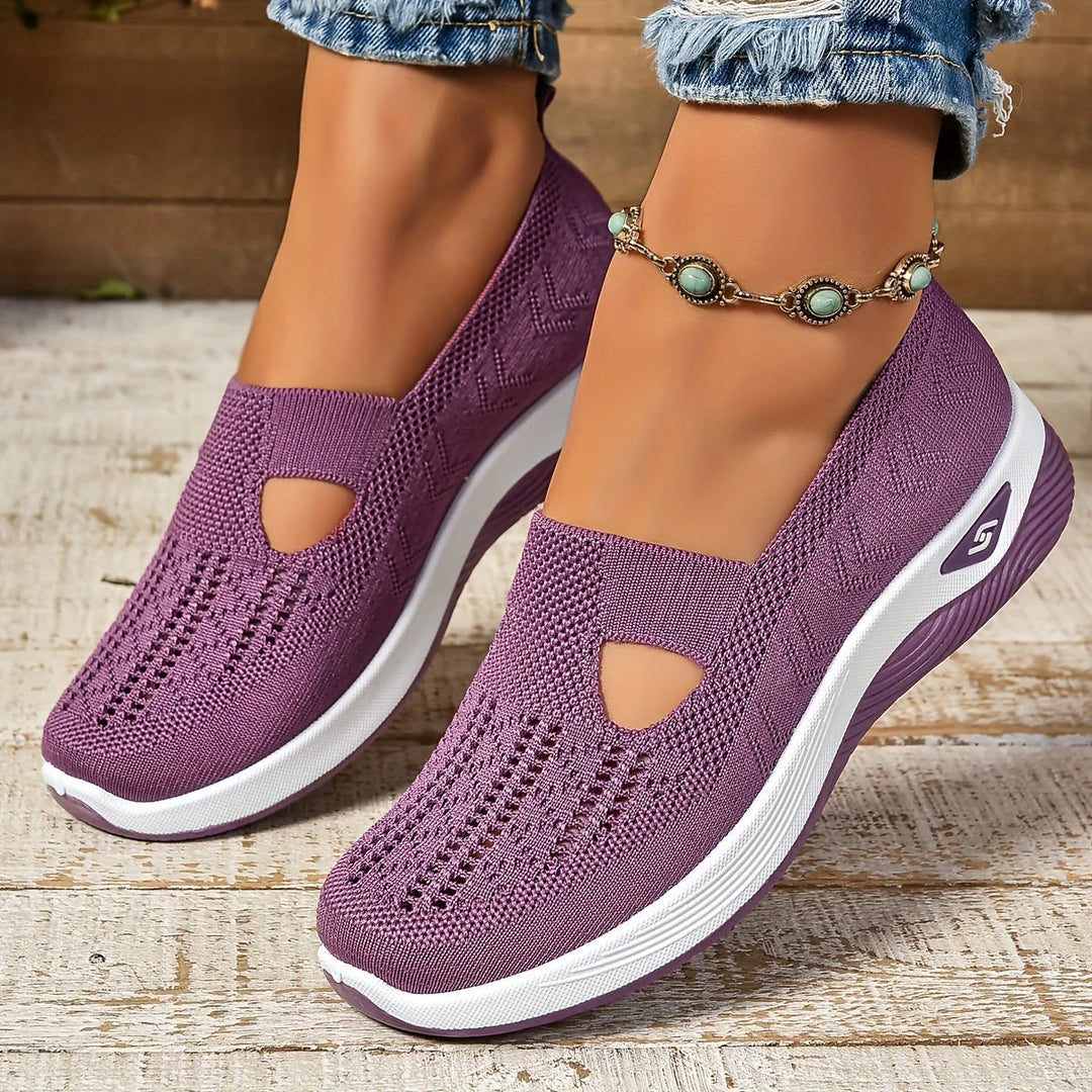 Women wearing purple non-slip orthopedic shoes with stretch knit upper and platform sole on outdoor steps