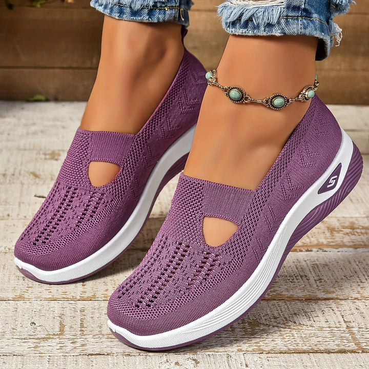 Women wearing purple non-slip orthopedic shoes with stretch knit upper and platform sole on outdoor steps