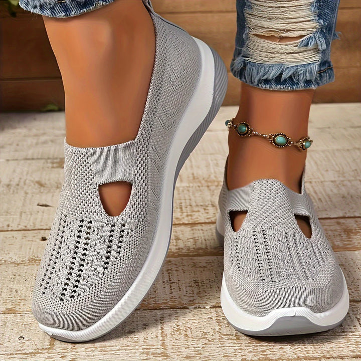Side angle of women's knit sneakers showing breathable upper and supportive platform construction