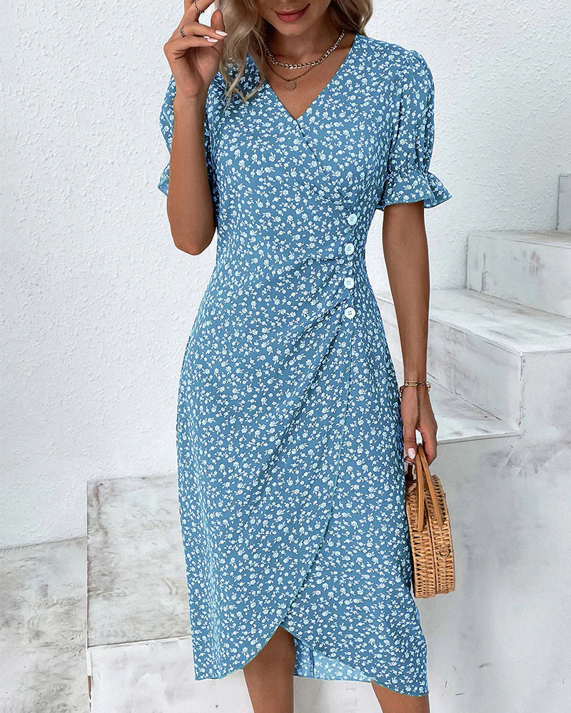 Close-up view of the floral print pattern and decorative button detail on a cotton summer dress
