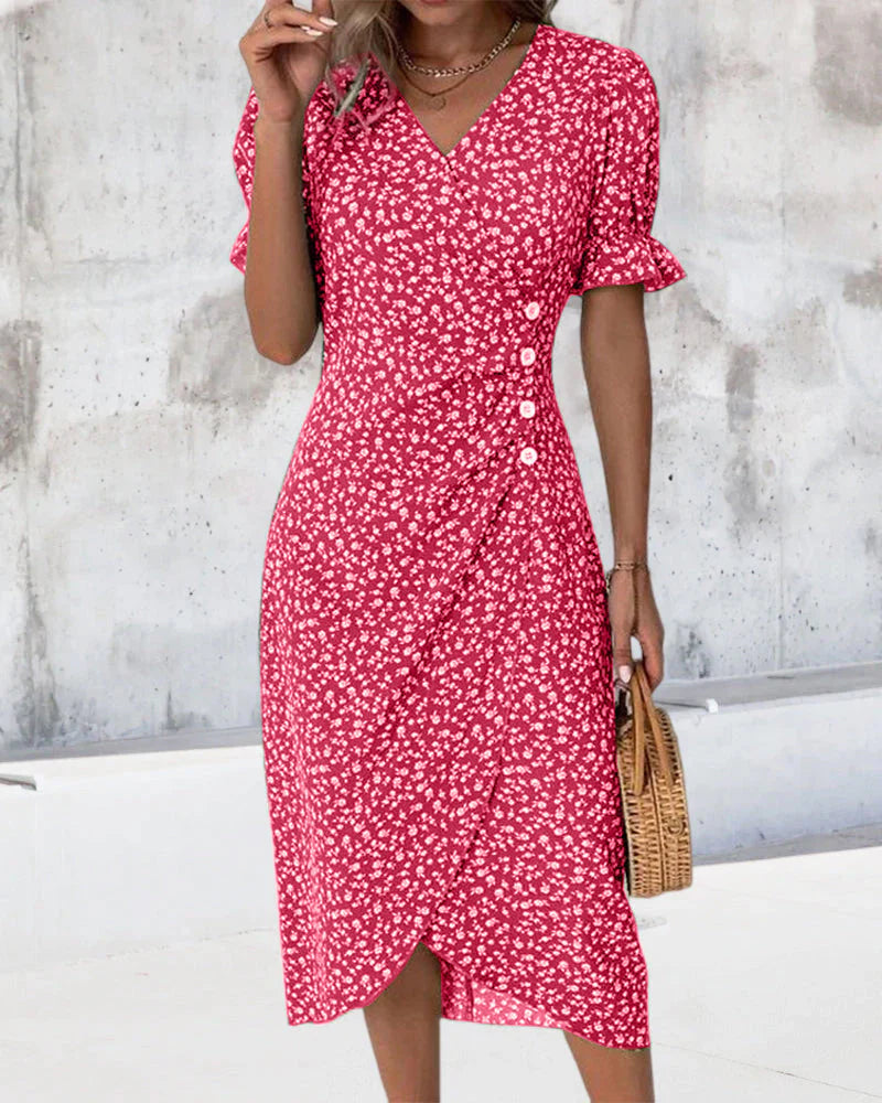 Detail of the V-neckline and flutter sleeves on a green floral cotton summer dress
