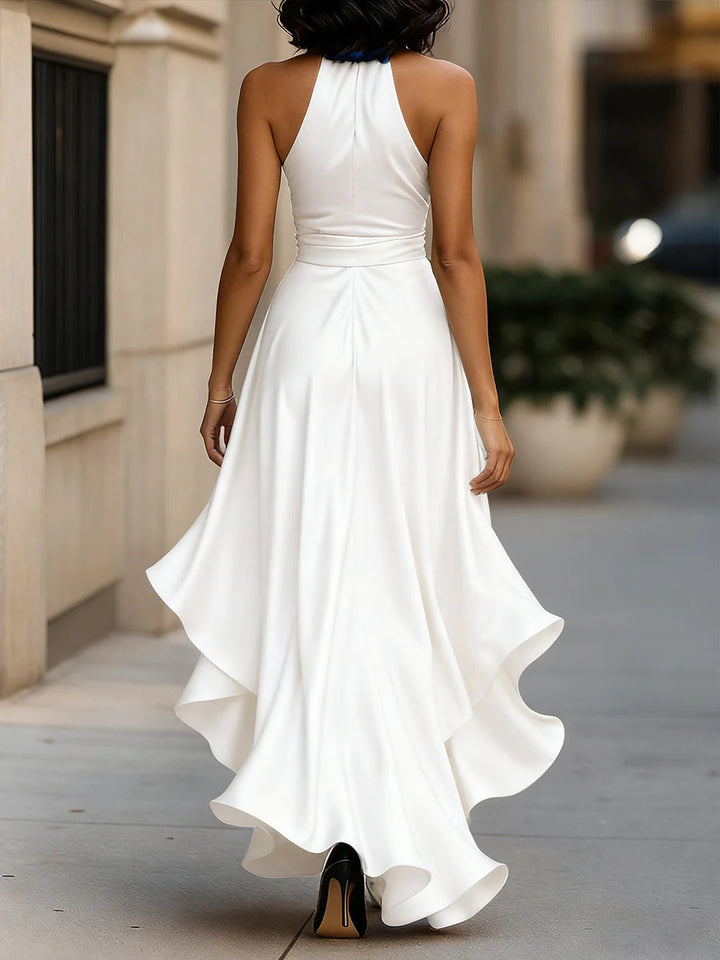 Model wearing halter neck ruffle maxi dress walking showing fabric drape and movement