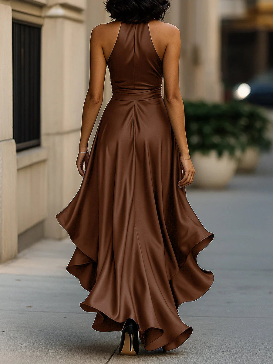 Detail of cascading ruffle hem layers on halter neck maxi dress in smooth fabric