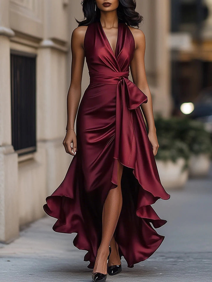 Halter neck ruffle maxi dress styled for formal evening event with heeled shoes