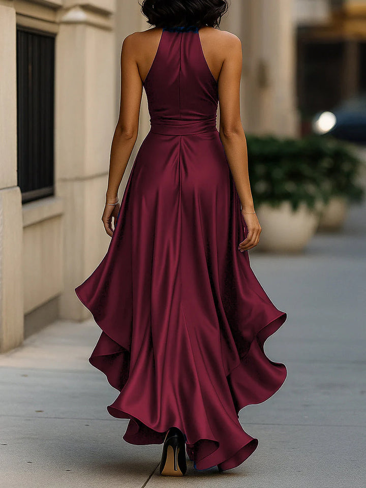 Three-quarter view of halter neck ruffle maxi dress highlighting wrap waist and ruffle detail