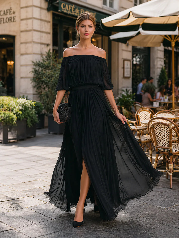 Flowing pleated maxi dress with off shoulder neckline and defined waist