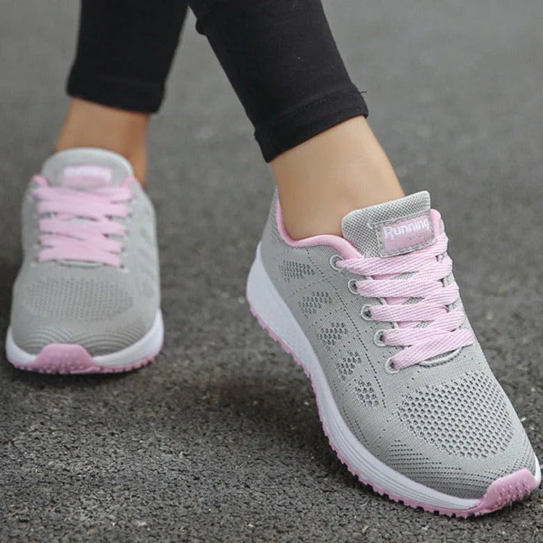 Women's orthopedic walking sneakers on pavement demonstrating slip-resistant sole and supportive construction