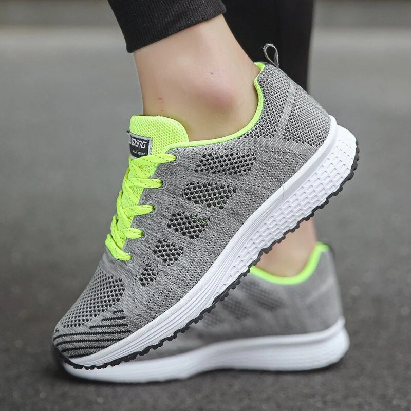 Detail of lace-up closure and padded collar on white mesh orthopedic walking shoes