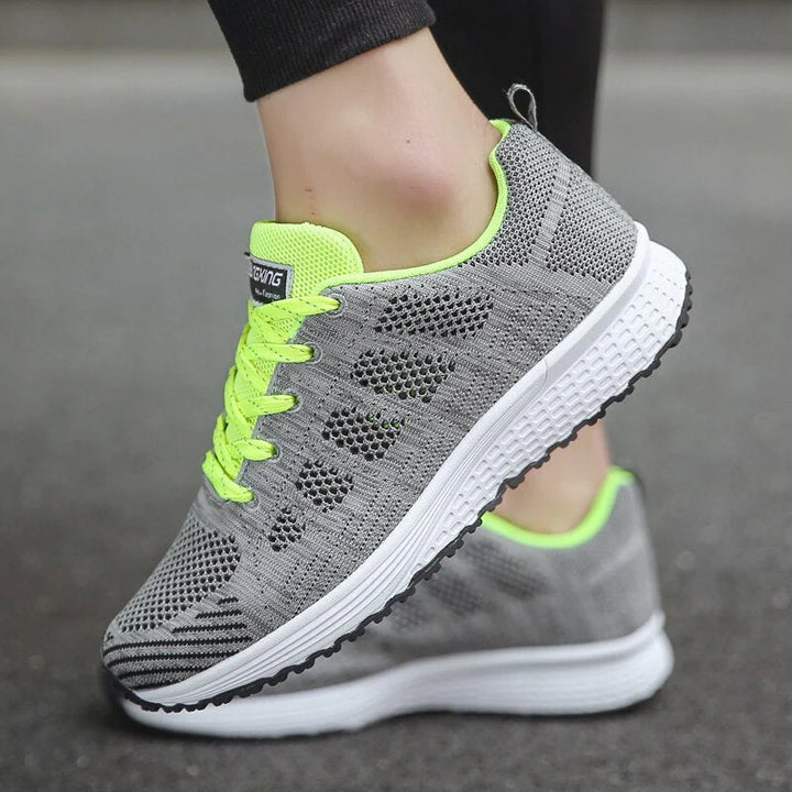 Detail of lace-up closure and padded collar on white mesh orthopedic walking shoes