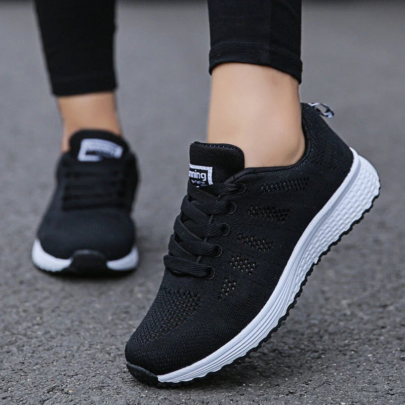 Women's lace-up orthopedic sneakers in white with breathable knit construction and arch support insole