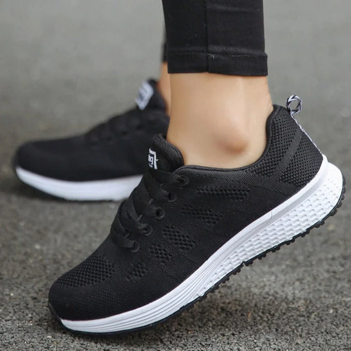 Detail of white walking shoes with elastic mesh upper and cushioned interior for comfortable daily steps