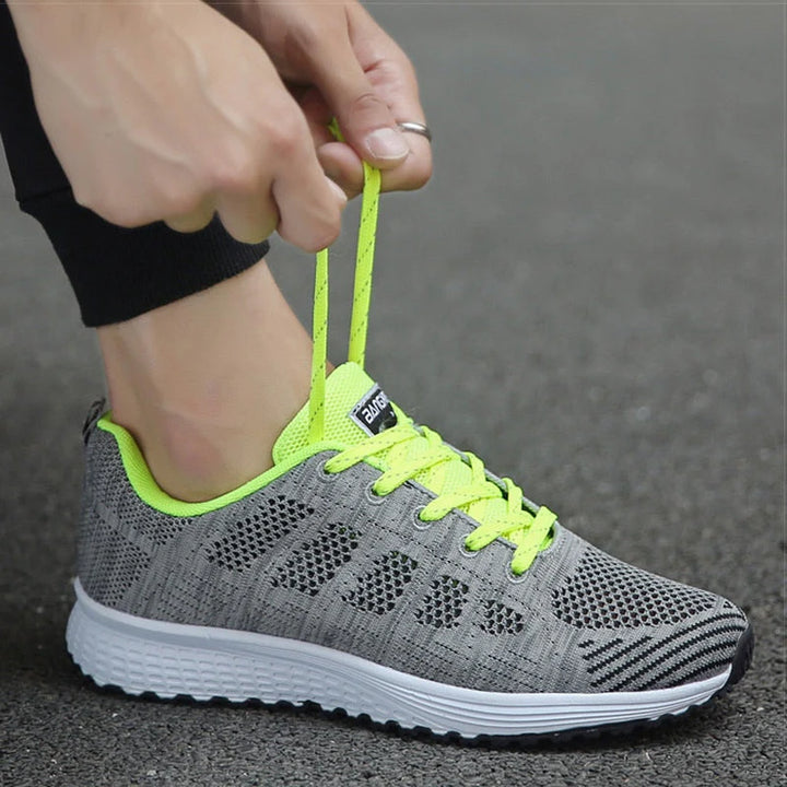 Front angle of white mesh sneakers with wide toe box design and padded interior for posture-friendly walking