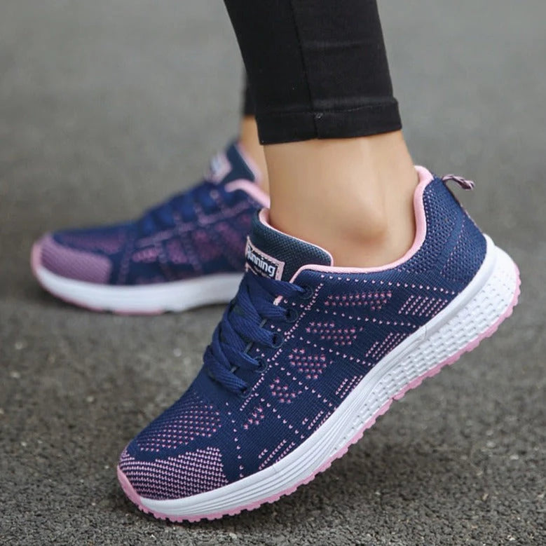 Women's breathable walking shoes in white featuring lace-up closure and shock-absorbing outsole for joint relief