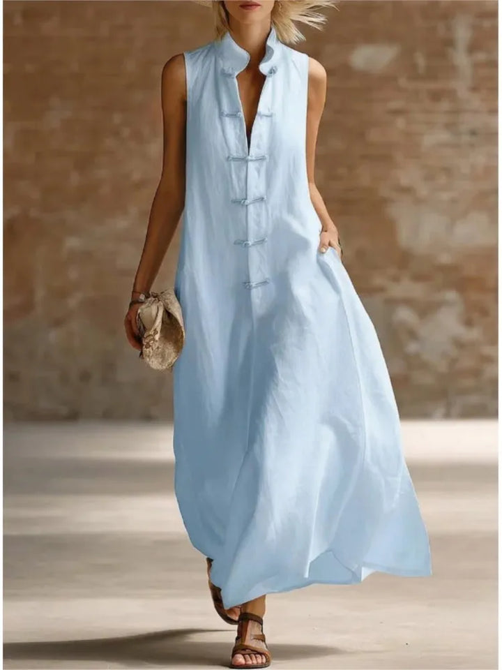 Sleeveless maxi dress in light blue with frog button closure and relaxed flowing silhouette