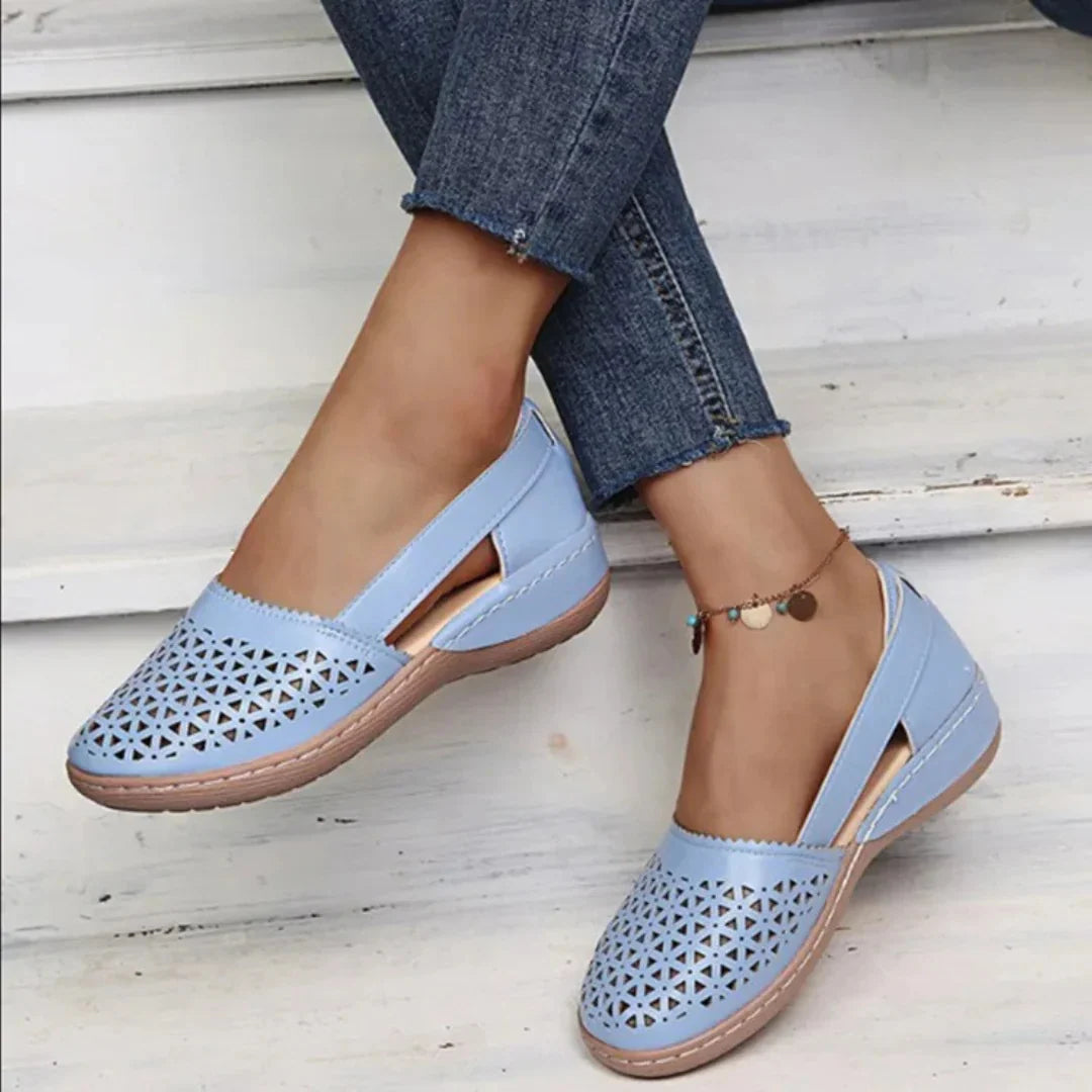 Violet Women's Orthopedic Comfort Walking Shoes with laser-cut detailing in light blue worn with jeans