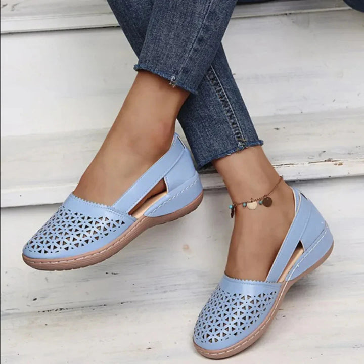 Violet Women's Orthopedic Comfort Walking Shoes with laser-cut detailing in light blue worn with jeans