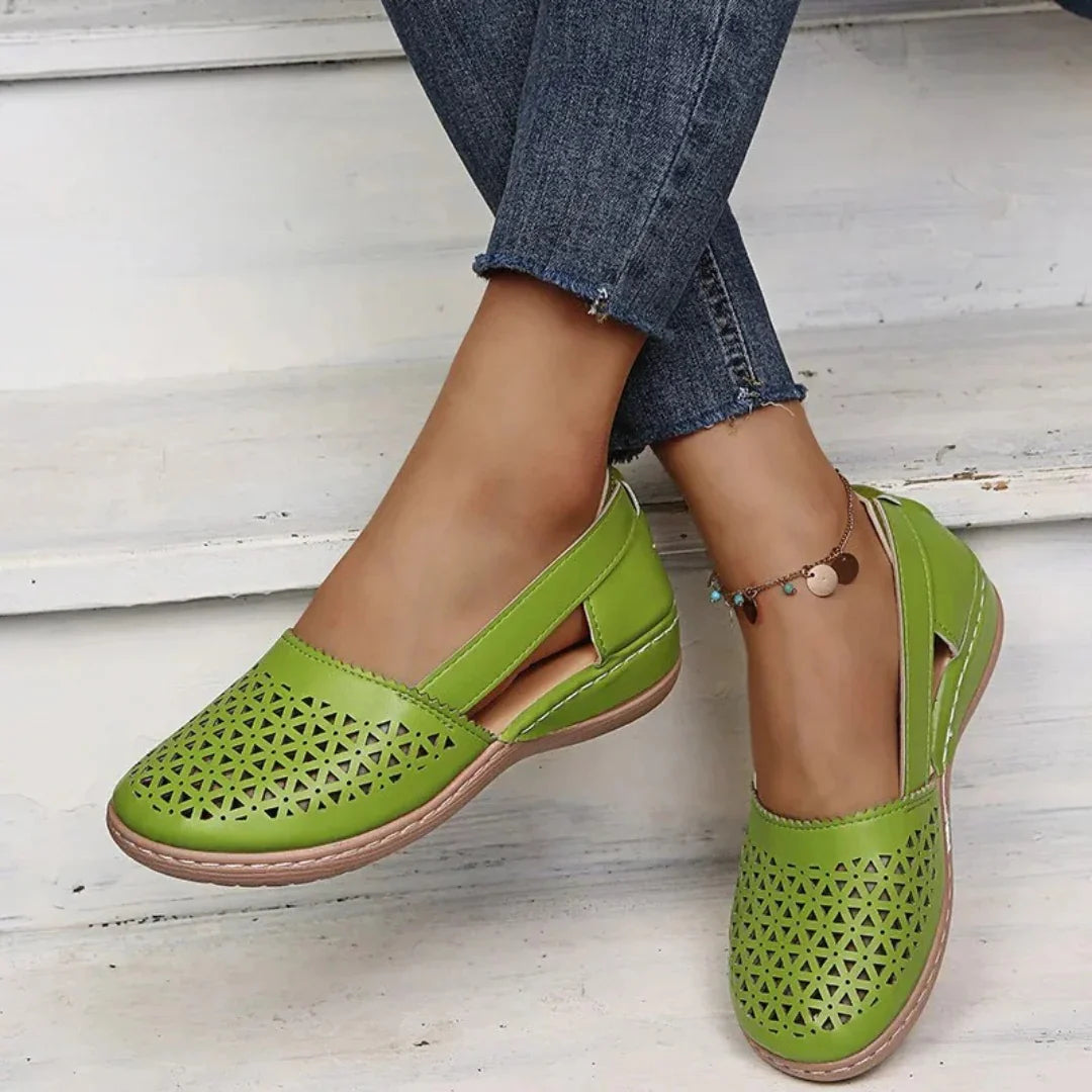 Women's orthopedic flats in light pink showing breathable perforated upper and supportive sole