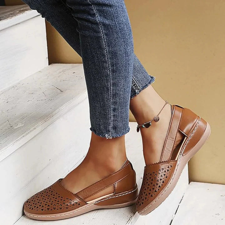 Detail of laser-cut geometric design on women's comfort walking shoes with smooth finish
