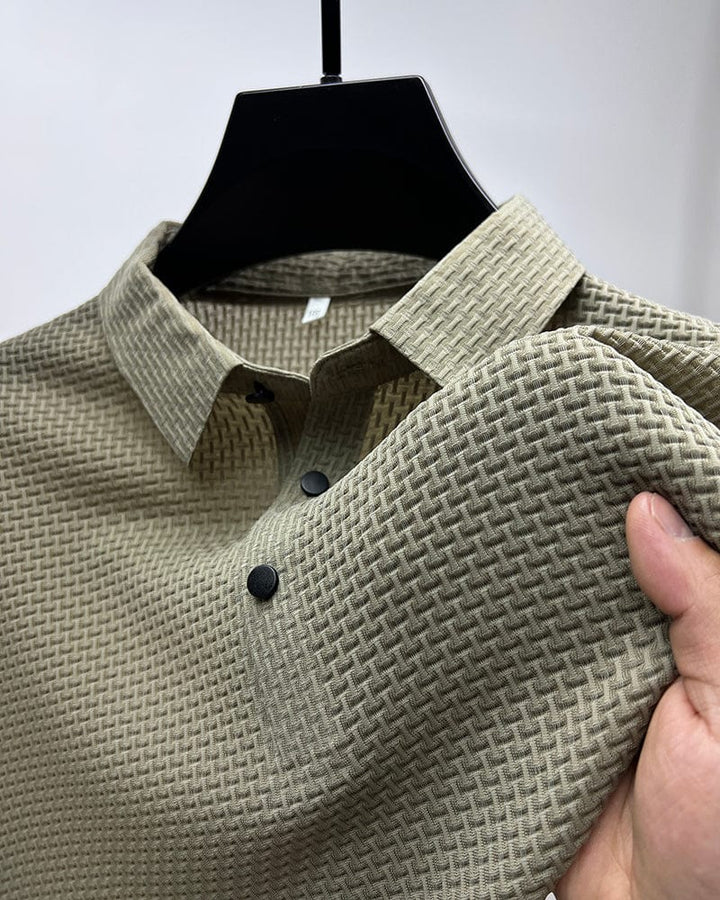 Men's gray polo shirt with structured collar and short sleeves on hanger