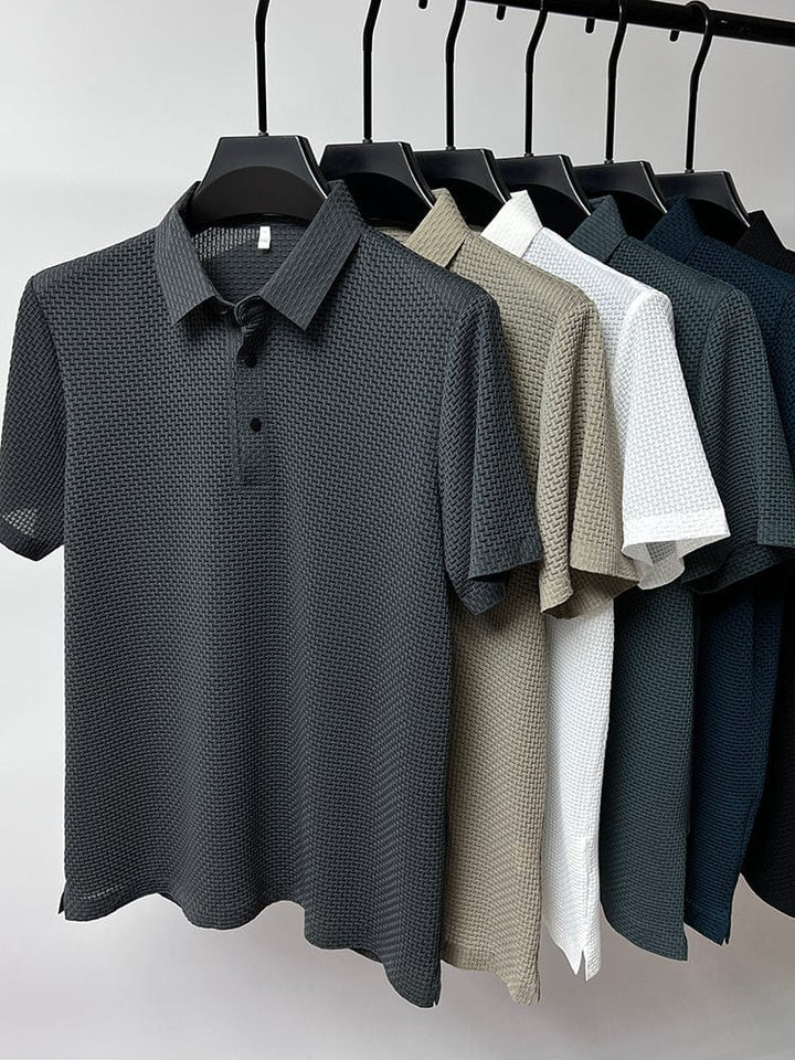 Close-up of polo shirt collar and button detail in textured mesh fabric