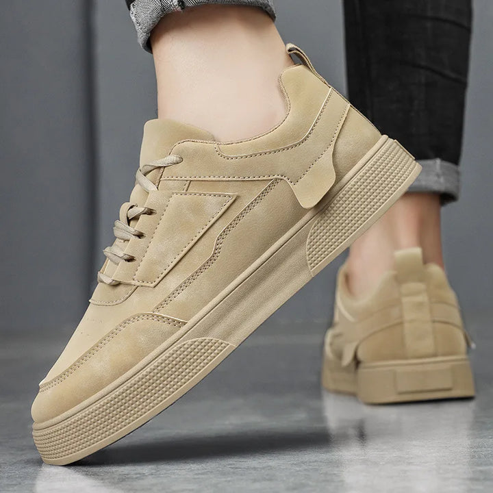 Side view of men's taupe low-top sneakers showing textured rubber outsole and padded collar