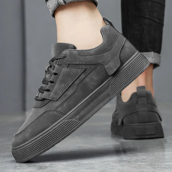 Pair of men's low-top sneakers showing cushioned sole design and neutral colorway