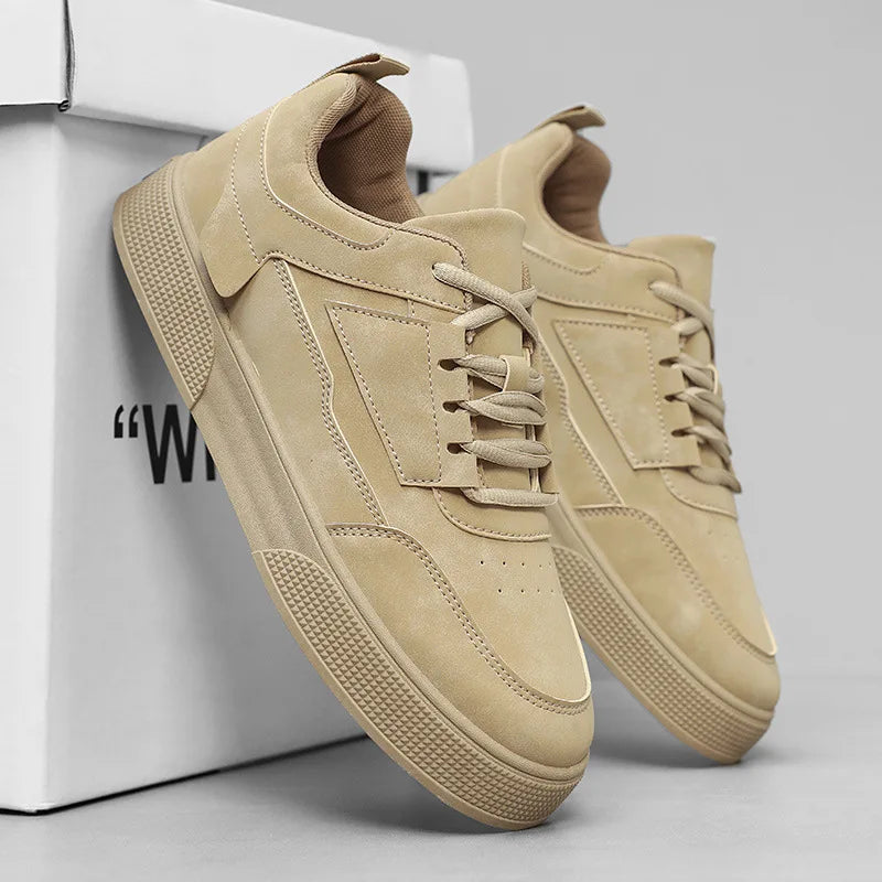 Men's taupe low-top sneakers on white background showing full lace-up closure and textured outsole