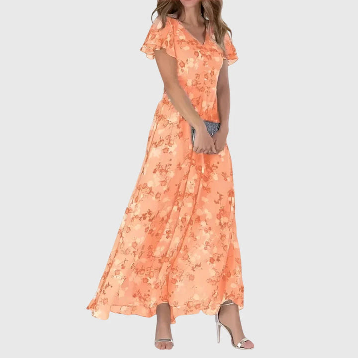 Floral Figure Flattering Dress in coral with flutter sleeves and V-neckline maxi length silhouette