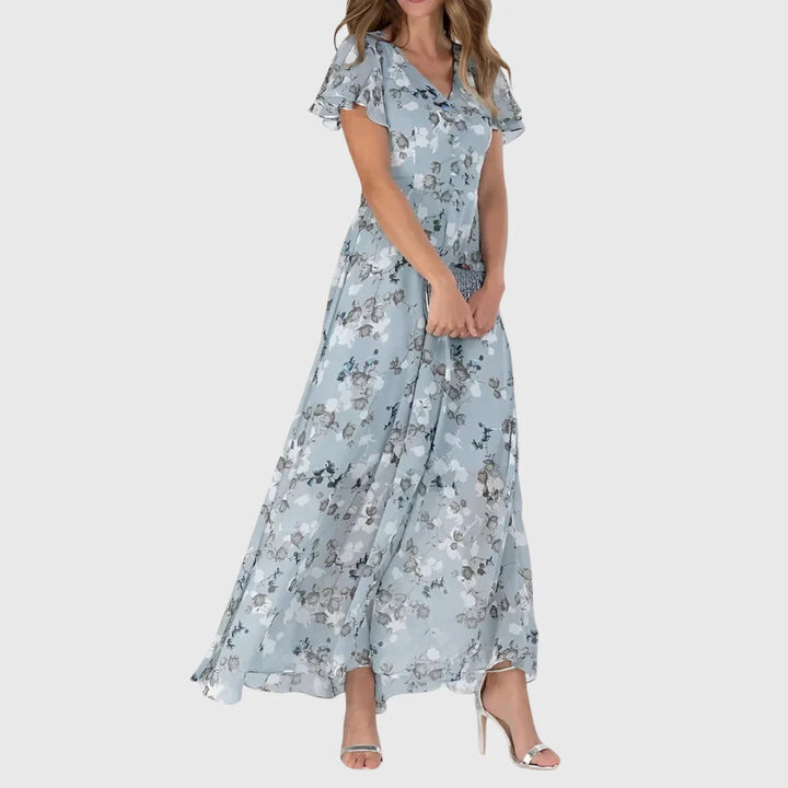 Side view of floral maxi dress showing flowing skirt and fitted bodice with flutter sleeves