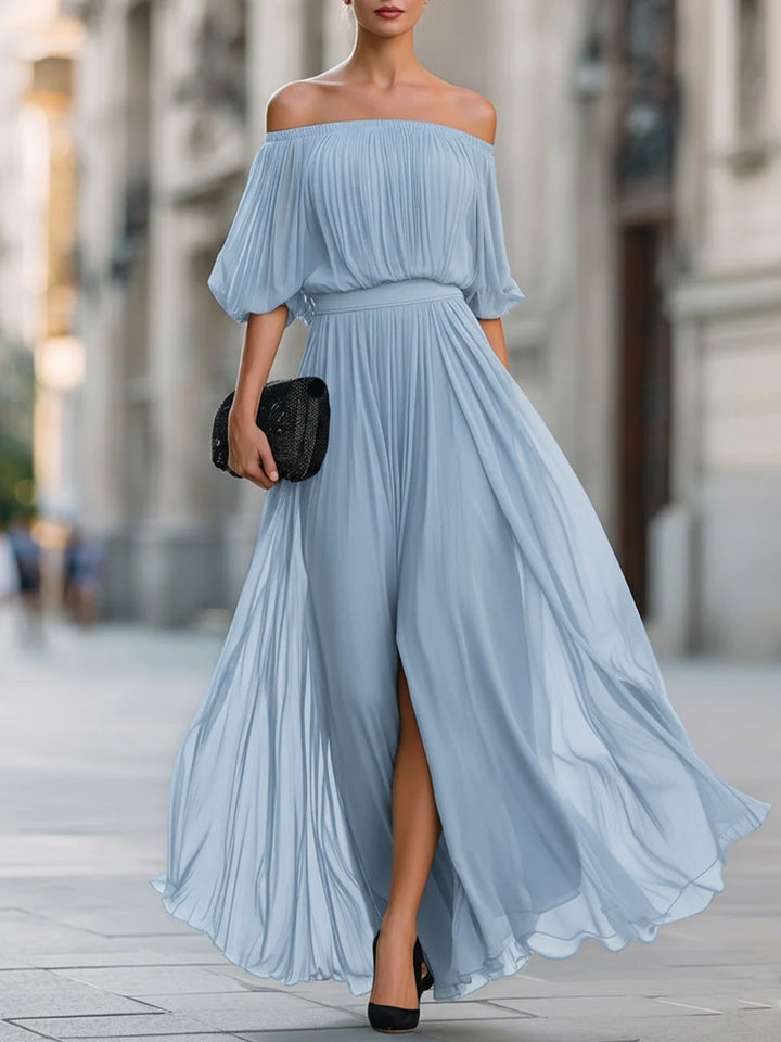 Full-length view of pleated maxi dress showing floor-length hem and movement of fabric
