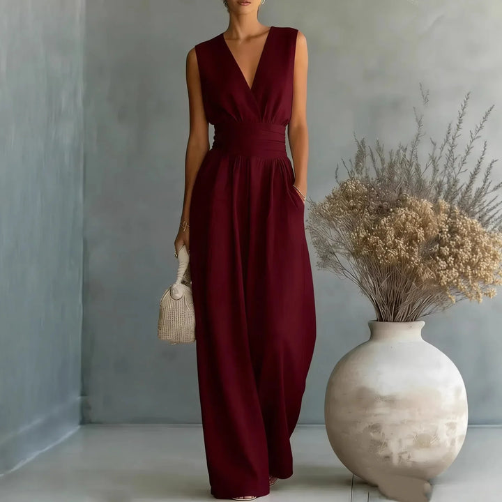 Front view of sleeveless V neck jumpsuit showing deep plunging neckline and flowing wide leg pants