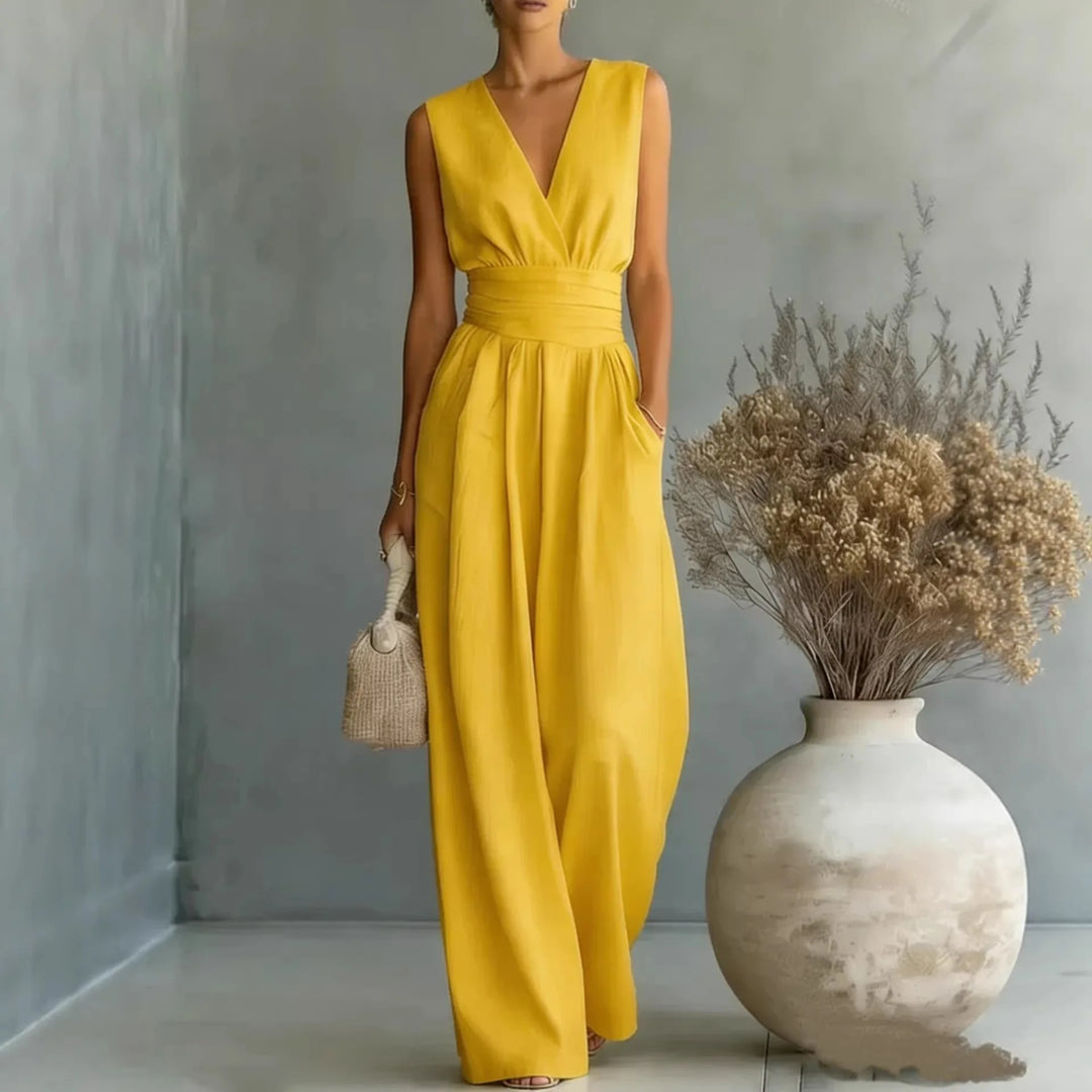 Side angle of high waist jumpsuit with V neckline and side pockets in soft blue fabric